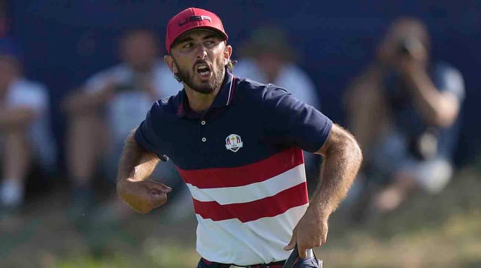 Max Homa celebrates as he wins his singles match 1 up on the 18th green at the 2023 Ryder Cup.